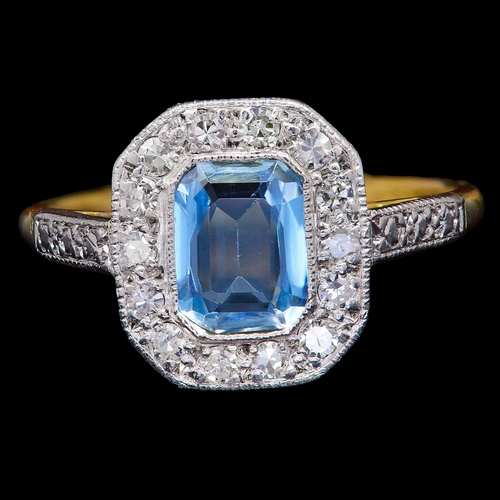 55 - AQUAMARINE AND DIAMOND DRESS RING, in 18 ct. gold and platinum. Set with a central aquamarine of app... 