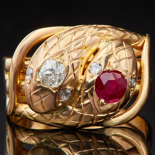 121 - RUBY AND DIAMOND DOUBLE SNAKE RING,designed as 2 coiled snakes, one set with a diamond to the head, ... 