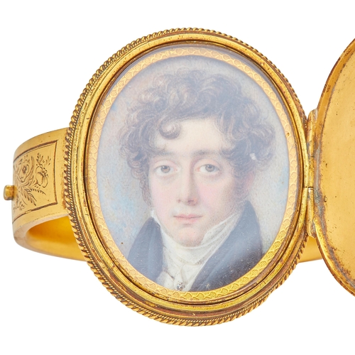 170 - LARGE PORTRAIT MINIATURE LOCKET BANGLE, the large oval centre egraved with initials and a wreath. Th... 