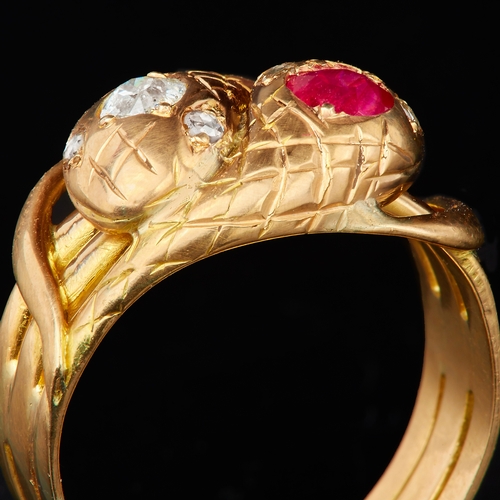 121 - RUBY AND DIAMOND DOUBLE SNAKE RING,designed as 2 coiled snakes, one set with a diamond to the head, ... 