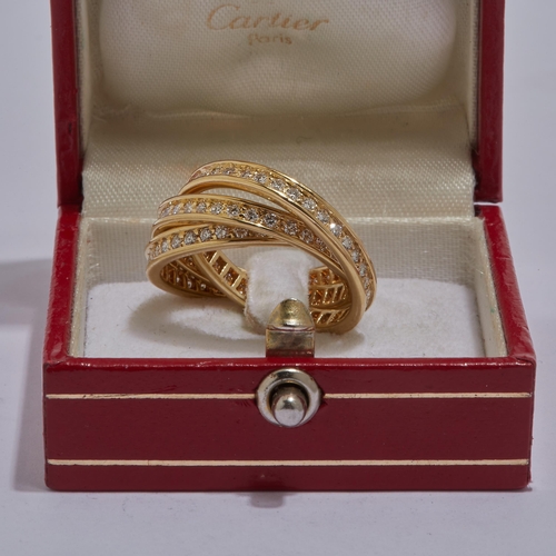 1 - CARTIER, DIAMOND TRINITY RING, in 18 ct. gold. All bands fully set with diamonds, totalling approx. ... 