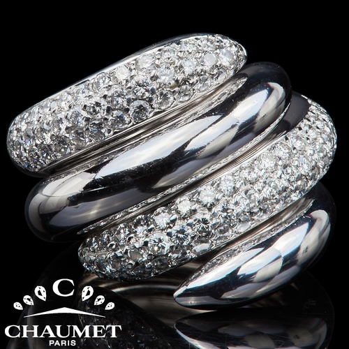 162 - CHAUMET, ' TANGO' DIAMOND RING, in 18 ct. gold. Designed as 2 interlocking swirls, of which one part... 