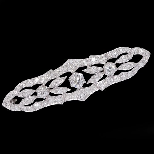 163 - DIAMOND BROOCH, set with a larger diamond to the centre, flanked with diamonds to the sides and surm... 