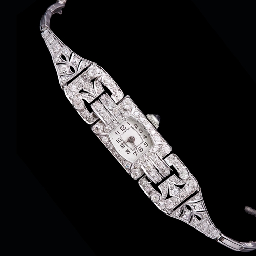 29 - DIAMOND LADIES DRESS WATCH, in platinum. The strap of part openwork design, set throughout with diam... 