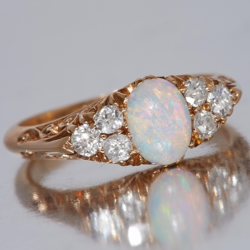 72 - OPAL AND DIAMOND RING, in 18 ct. gold. Set with diamonds totalling approx. 0.50 ct. Size N. 4.7 gram... 