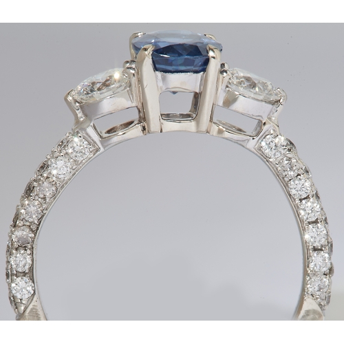 1 - SAPPHIRE AND DIAMOND DRESS RING, in 18 ct. white gold. Set to the center with a blue sapphire of app... 