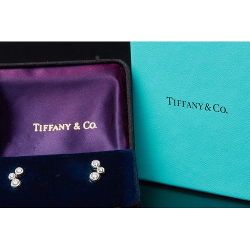 149 - TIFFANY & CO, PAIR OF DIAMOND EARRINGS, in platinum. Designed as 3 diamonds, graduated in size. Sign... 