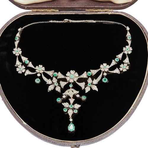 163 - ANTIQUE EMERALD AND DIAMOND DROP NECKLACE, designed as floral clusters, set with an emerald to the c... 