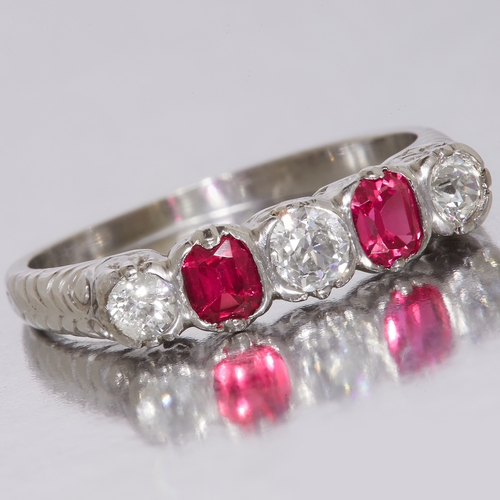 230 - 5-STONE RUBY AND DIAMOND DRESS RING, Set with 2 rubies, totalling approx. 0.42 ct. Flanked with 3 di... 