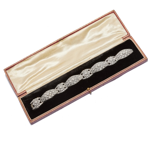 257 - IMPRESSIVE ART DECO DIAMOND BRACELET. Each link of openwork design, set with a larger diamond to the... 