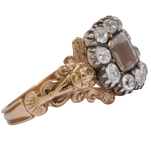 331 - VICTORIAN DIAMOND MEMORI RING, the centre set with an entwined hairwork behind a domed glass. Surrou... 