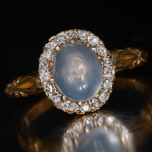 135 - MOONSTONE AND DIAMOND CLUSTER RING, Set with a central cabochon cut moonstone, surrounded with diamo... 