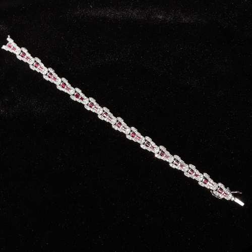 40 - RUBY AND DIAMOND BRACELET, The links of triangular design, set with diamonds to the sides and 2 rubi... 