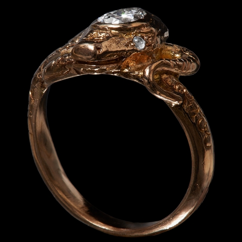 48 - DIAMOND SNAKE RING, in 18 ct. gold. Designed as a curled snake, set with a pear shaped diamond to th... 