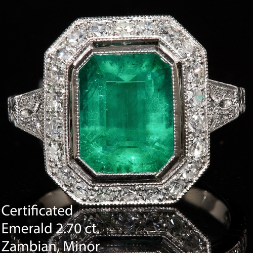 87 - CERTIFICATED EMERALD AND DIAMOND CLUSTER RING, set with a central emerald of 2.70 ct. Surrounded wit... 