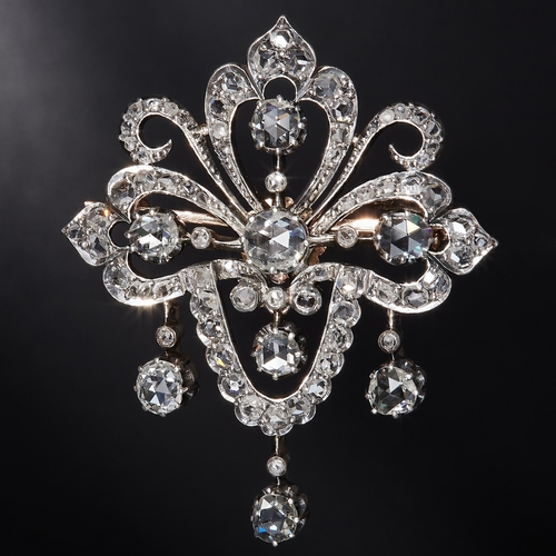 95 - VICTORIA DIAMOND DROP BROOCH, of openwork, part scrolling design. Set with diamonds totalling approx... 