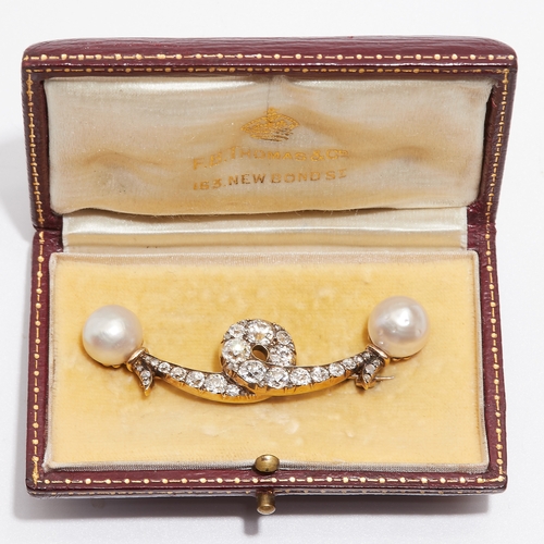 12 - IMPRESSIVE TWO PEARL SET ON A BROOCH WITH DIAMONDS. set with two cream natural saltwater pearls with... 