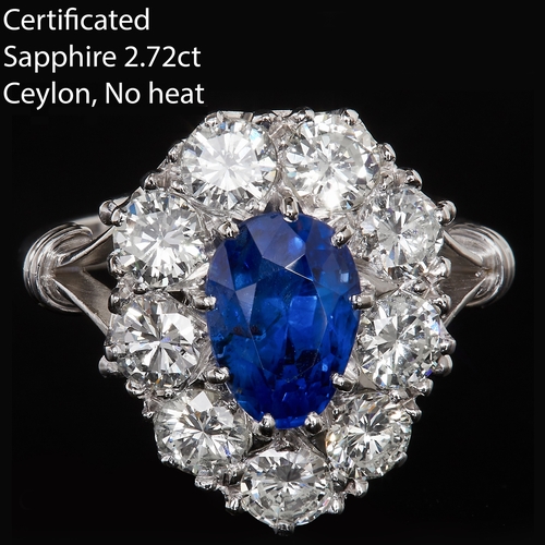 50 - IMPRESSIVE SAPPHIRE AND DIAMOND CLUSTER RING. In 18 ct. gold and platinum. Set with a large intense ... 