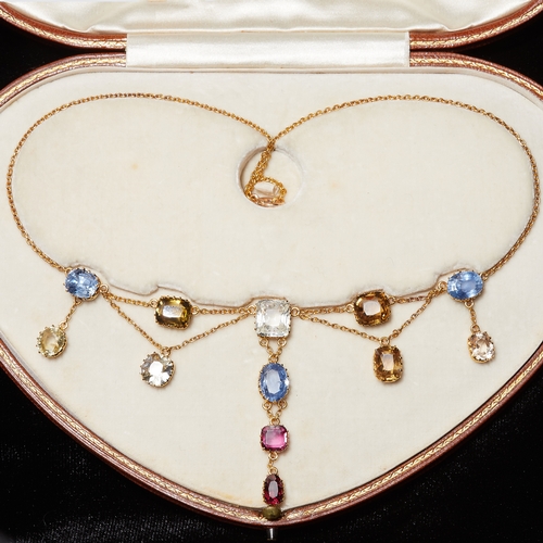 137 - EDWARDIAN MULTI-COLOUR GEMSTONE NECKLACE, including sapphires and rubies. Sapphires totalling approx... 