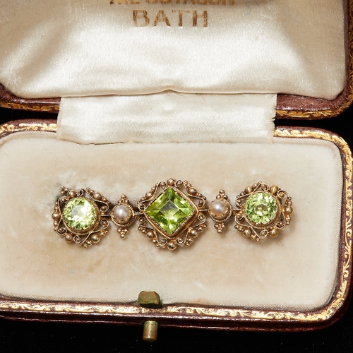 147 - GEORGIAN PERIDOT AND PEARL BROOCH, the surmount with canetille work. W. 3.8 cm. 3.6 grams.