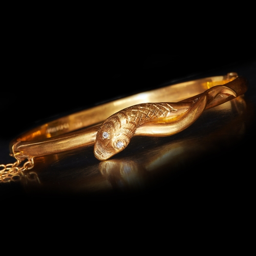 200 - ANTIQUE VICTORIAN GOLD SNAKE BANGLE WITH DIAMOND EYES. set with bright lively diamonds, with a coile... 