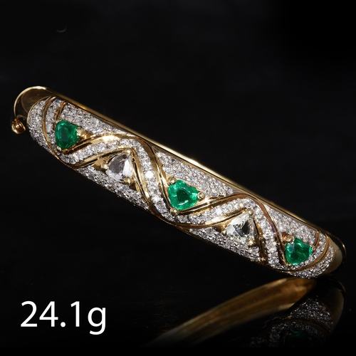 24 - IMPRESSIVE EMERALD AND DIAMOND HINGED BANGLE. stamped 750. set with three heart shaped emeralds tota... 