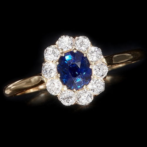 5 - SAPPHIRE AND DIAMOND CLUSTER RING, Set with a vibrant sapphire and bright and lively sapphires. Size... 