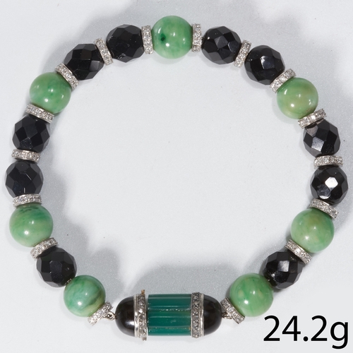 175 - ART-DECO DIAMOND, JET, JADE AND BLOODSTONE BRACELET,
The carved jet and jade accentuated with daimon... 