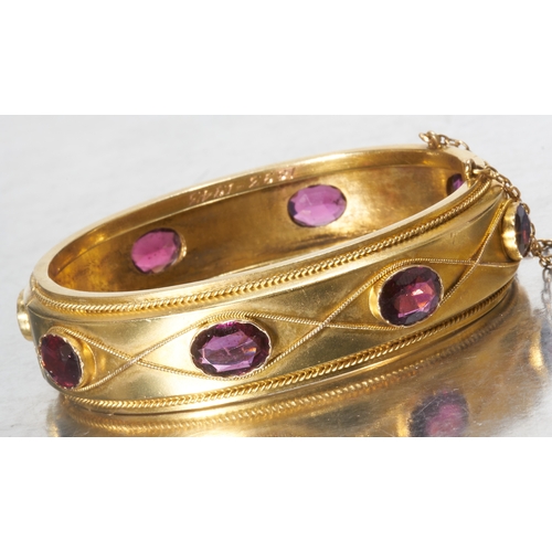 114 - ANTIQUE VICTORIAN GARNET ETERNITY HINGED BANGLE,
24.1 grams, High carat gold.
Set with 6 vibrant gar... 