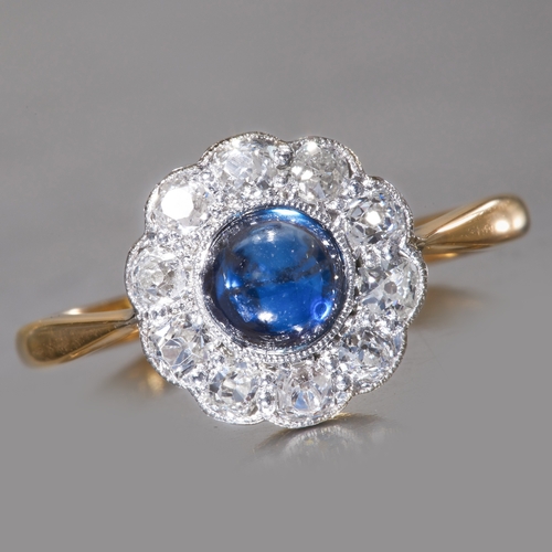 215 - SAPPHIRE AND DIAMOND CLUSTER RING,
2.6 grams, 18 ct. gold and platinum.
Vibrant cabochon cut sapphir... 