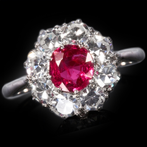 231 - RUBY AND DIAMOND CLUSTER RING.
2.9 gram. 18 ct. gold and platinum.
Set with vibrant rich colour ruby... 