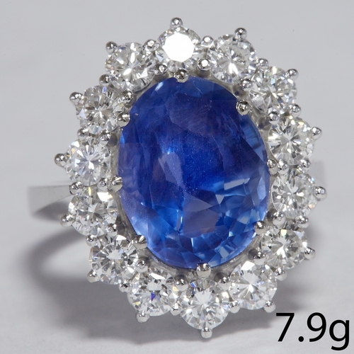 21 - 5.75 CT, SAPPHIRE AND DIAMOND CLUSTER RING.
7.9 grams, 18 ct. white gold.
Set with rich vibrant blue... 