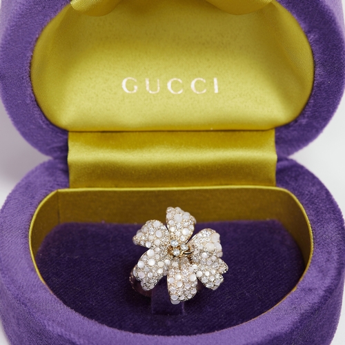 114 - GUCCI 'FLORA', RARE LARGE DIAMOND AND MOONSTONE RING,
13 grams, 18 ct. gold.
Diamonds bright and liv... 