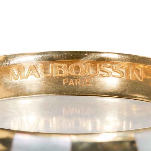 73 - MAUBOUSSIN, MOTHER OF PEARL HINGED BANGLE,
53.8 grams, 18 ct. gold.
The top in alternated pattern, s... 