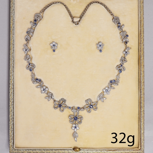 187 - FINE BELLE EPOQUE SAPPHIRE AND DIAMOND SUITE, necklace and earrings.
32 grams.
Fine floral and bow d... 