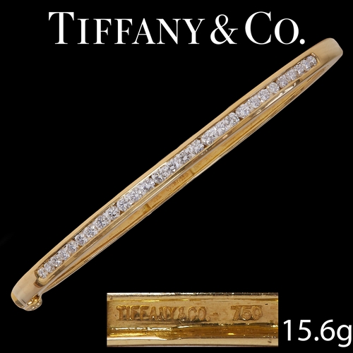 205 - TIFFANY & CO, DIAMOND HINGED BANGLE,
15.6 grams, 18 ct. gold.
Diamonds bright and lively.
Signed Tif... 