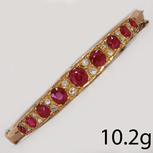 39 - EDWARDIAN RUBY AND DIAMOND HINGED BANGLE,
10.2 grams, testing high carat gold.
Vibrant rubies, total... 