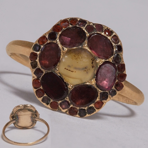 150 - VICTORIAN DENDRITIC AGATE AND GARNET CLUSTER RING,
2.5 grams, testing 15 ct. gold.
Cabochon cut dend... 