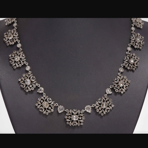 76 - UNUSUAL ANTIQUE DIAMOND NECKLACE,
65.3 grams.
fine diamond set clusters, each alternated with a sing... 