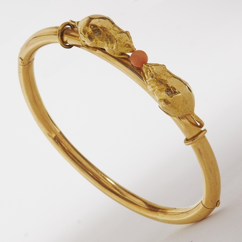 55 - THORNHILL & CO, CORAL DOUBLE MOUSE GOLD HINGED BANGLE,
15.6 grams,
Both mouses with tail around the ... 