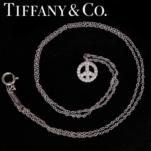 155 - TIFFANY & CO, DIAMOND PEACE SYMBOL PENDANT NECKLACE,
18 ct. gold.
The pendant set with bright and li... 