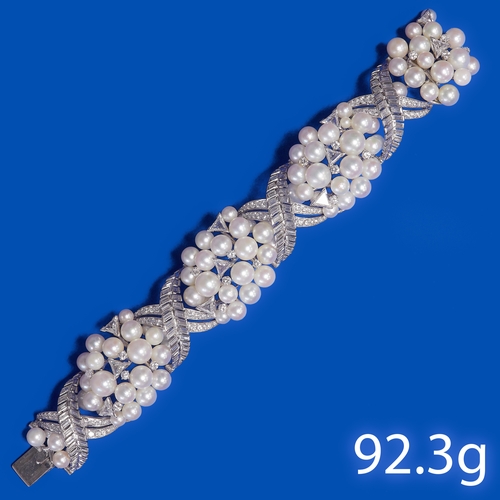 153 - FINE AND MAGNIFICENT PEARL AND DIAMOND BRACELET,
92.3 grams, testing 18 ct. gold.
The pearls general... 