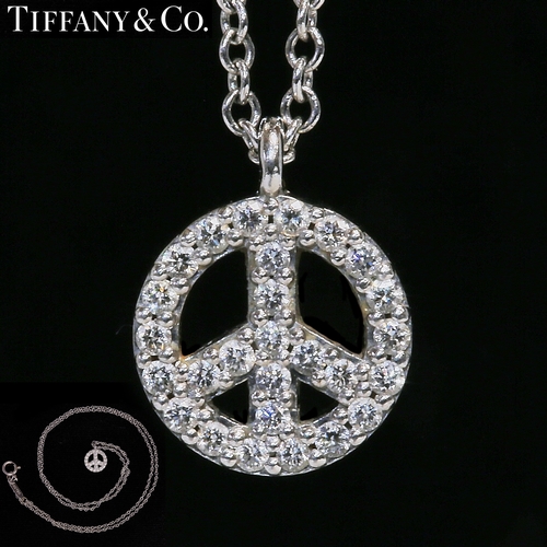 23 - TIFFANY & CO, DIAMOND PEACE SYMBOL PENDANT NECKLACE,
18 ct. gold.
The pendant set with bright and li... 