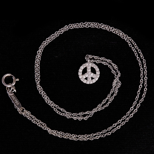 23 - TIFFANY & CO, DIAMOND PEACE SYMBOL PENDANT NECKLACE,
18 ct. gold.
The pendant set with bright and li... 