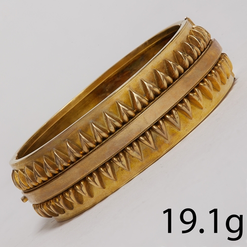 35 - ETRUSCAN REVIVAL HINGED BANGLE,
19.1 grams, testing 15 ct. gold.
The top with fine relief decoration... 