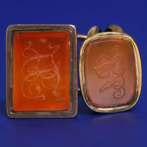 154 - TWO ANTIQUE GOLD FOB SEALS ON RING.
32.7 grams. Testing high carat gold.
H. 3.4 and 3.4 mm.