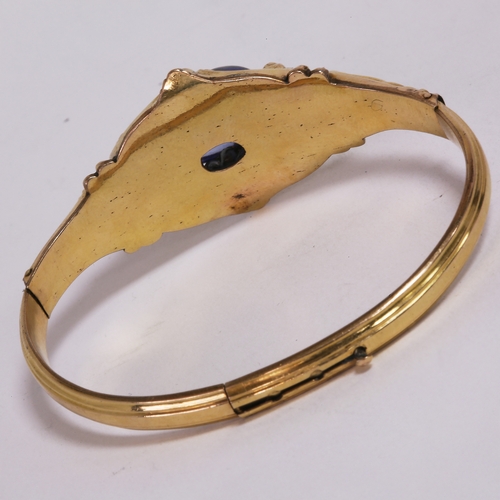 3 - VICTORIAN SAPPHIRE HINGED BANGLE,
13 grams, testing high carat gold.
Large sapphire of approx. 19.10... 