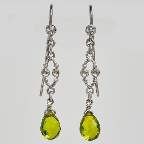 74 - ELEGANT PAIR OF DIAMOND AND PERIDOT EARRINGS 
platinum 
lively diamonds 
rich vibrant peridots 
L 3.... 