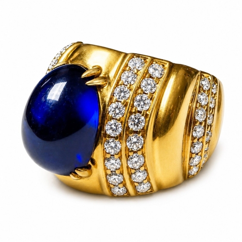 120 - ERIC BERTRAND, SAPPHIRE AND DIAMOND RING,
 9.5 grams, 18 ct. gold.
Rich and vibrant cabochon cut sap... 