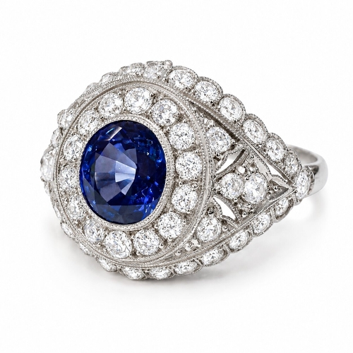 92 - SAPPHIRE AND DIAMOND CLUSTER RING 
4.8 grams high carat gold and platinum 
rich vibrant sapphire wit... 